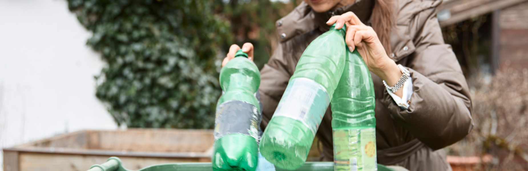 Woman recycling plastic bottles