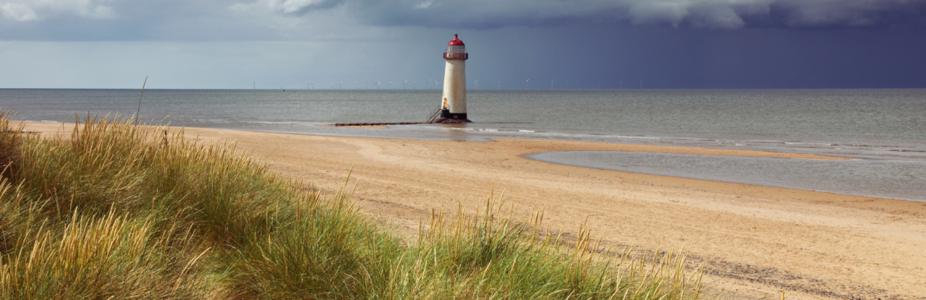Beach in Flintshire with lighthouse in the distance