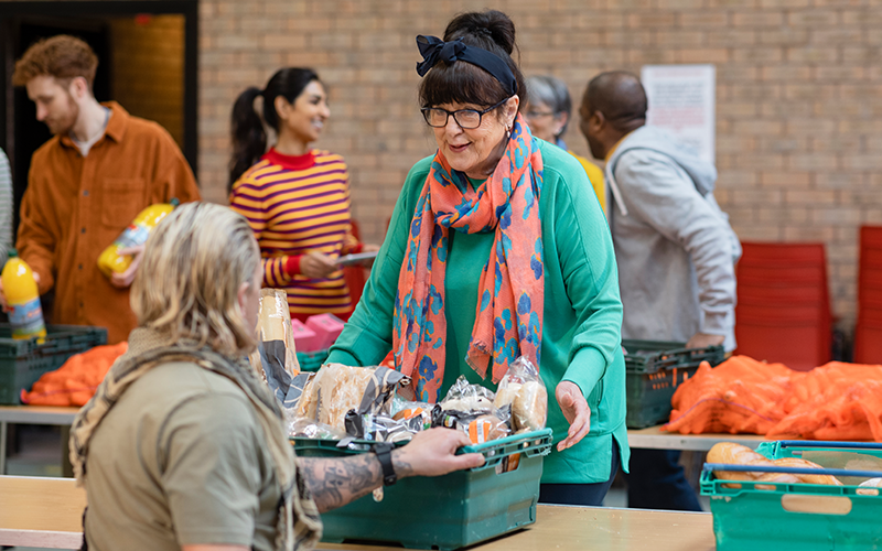 A woman collecting food from a food bank