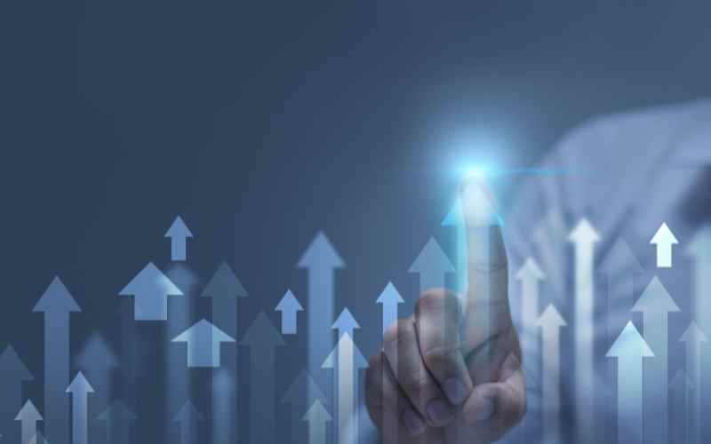 Finger pointing at glowing spot with arrows symbolising progress