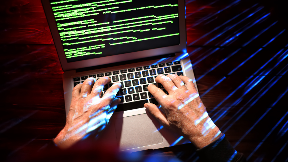 A man using a laptop in the dark