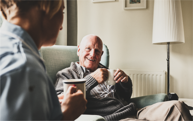 Person smiling with a mug of tea