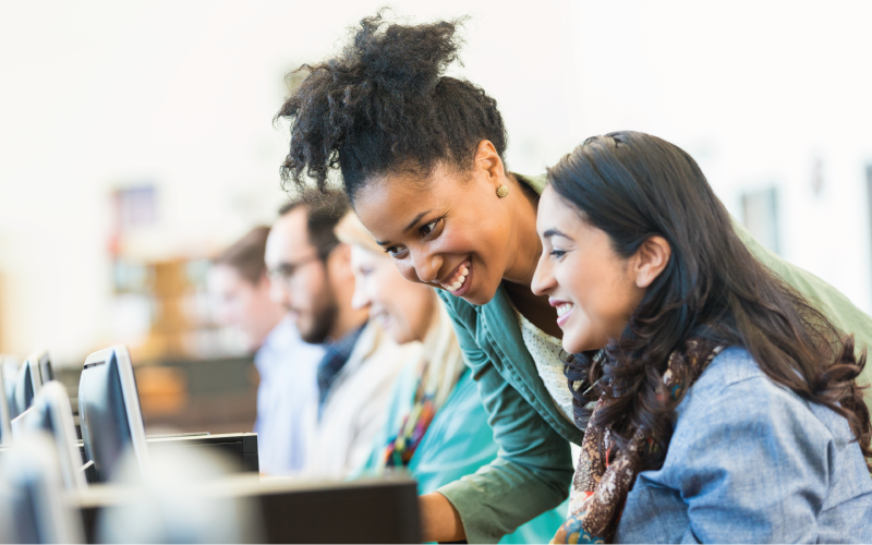 student and adult learning at a computer