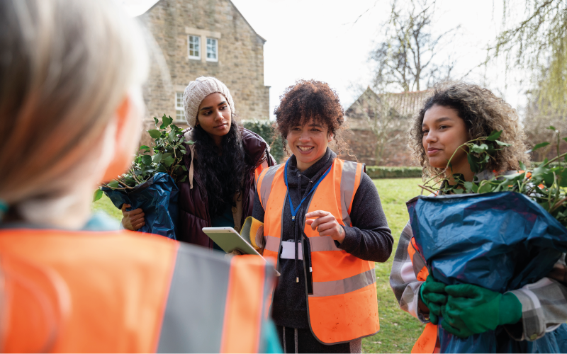 four people gardening in the community