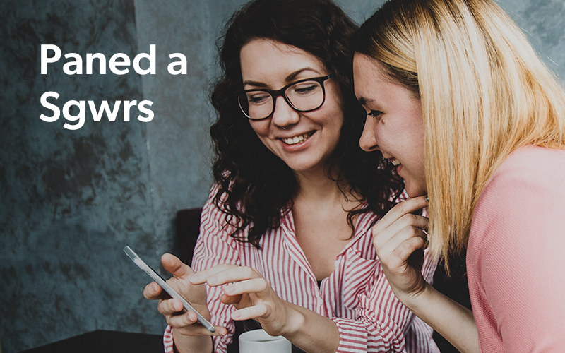 Image showing two women enjoying a conversation over a beverage and a phone.