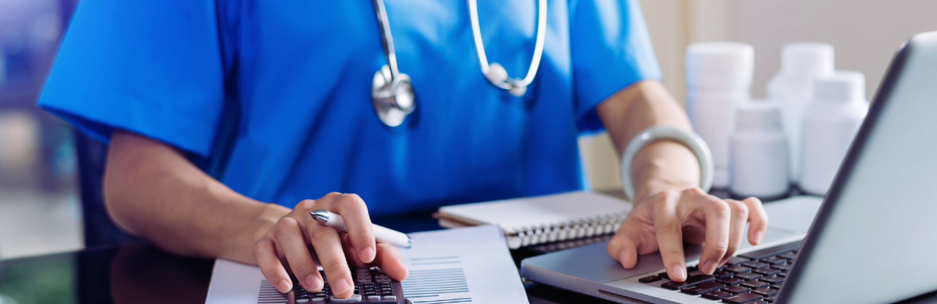 picture of a doctor working at a laptop