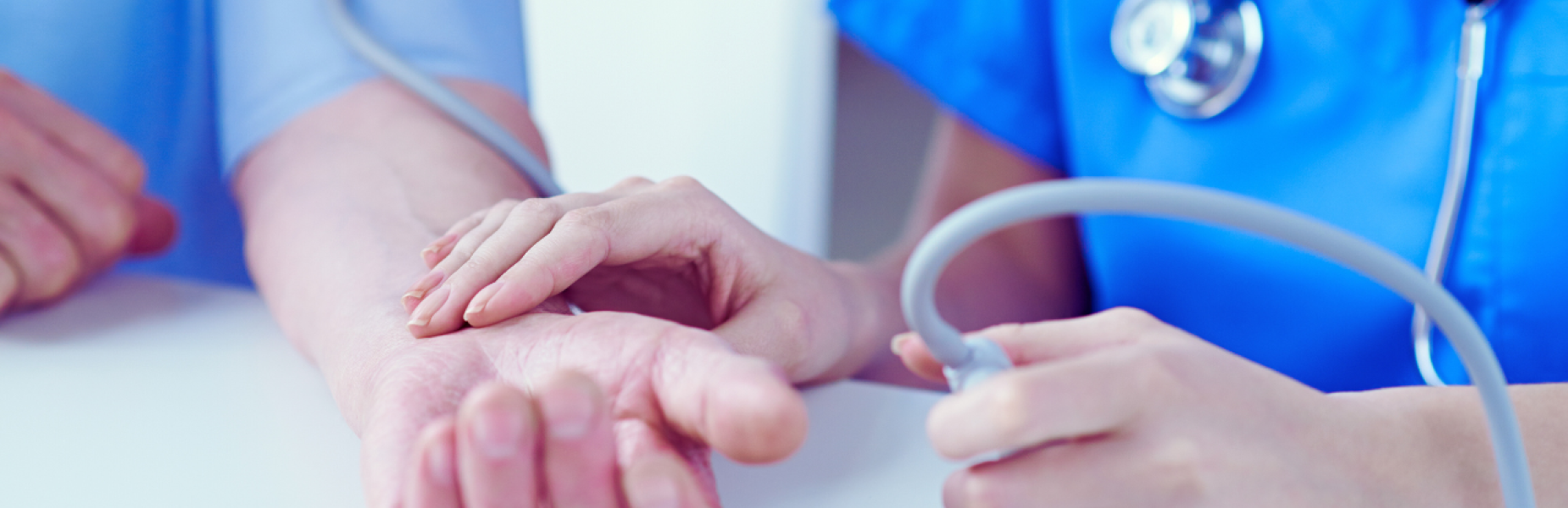 a picture of a nurse taking a patient's pulse